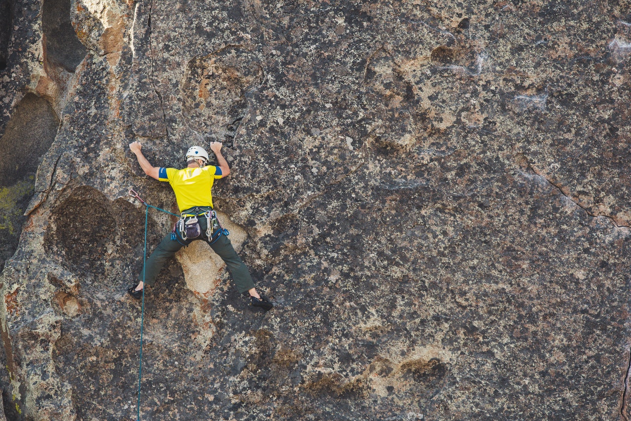 man doing outdoor rock climbing 1574216